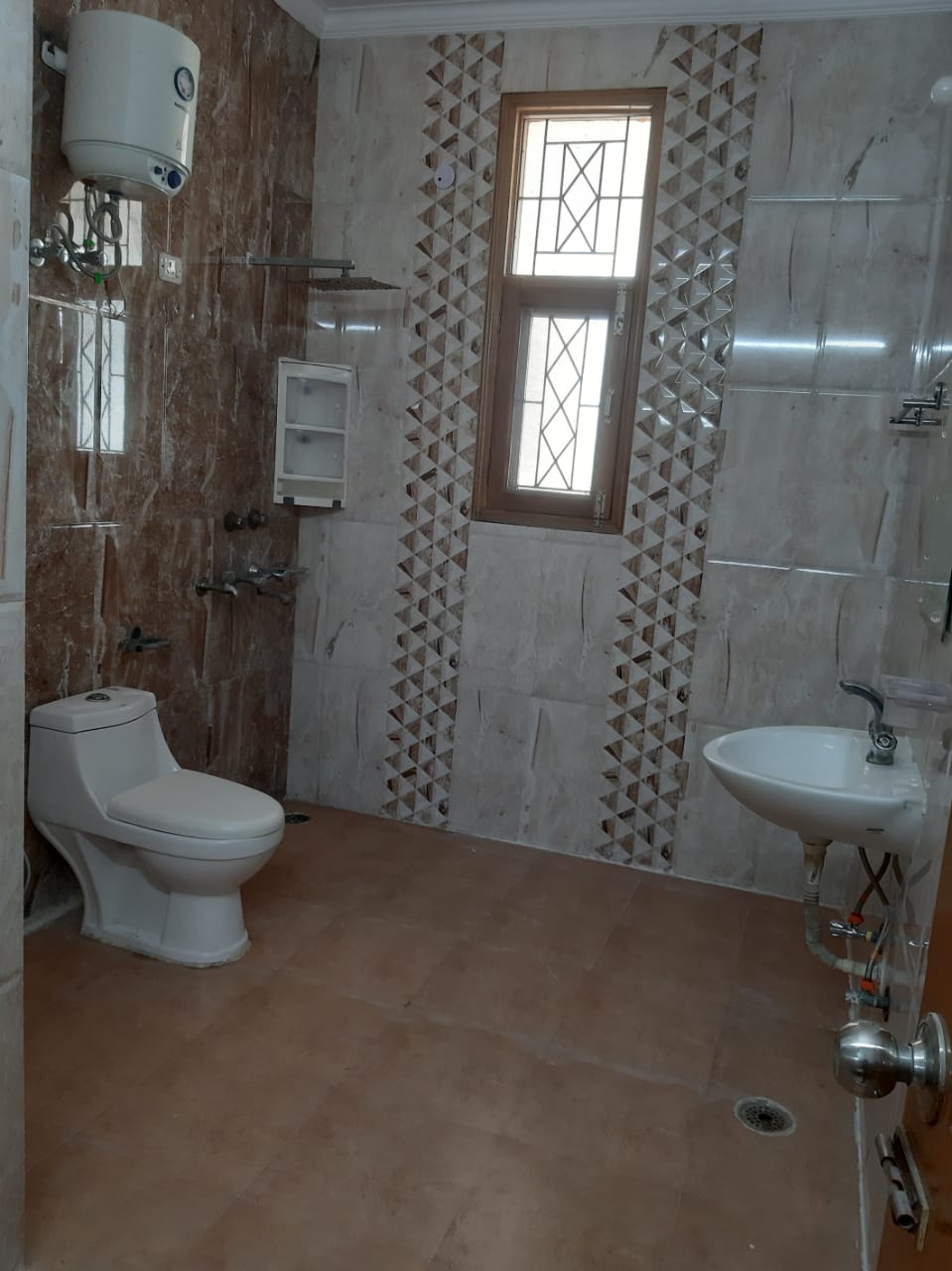 A bathroom in one of our houses, with geyser and running hot water